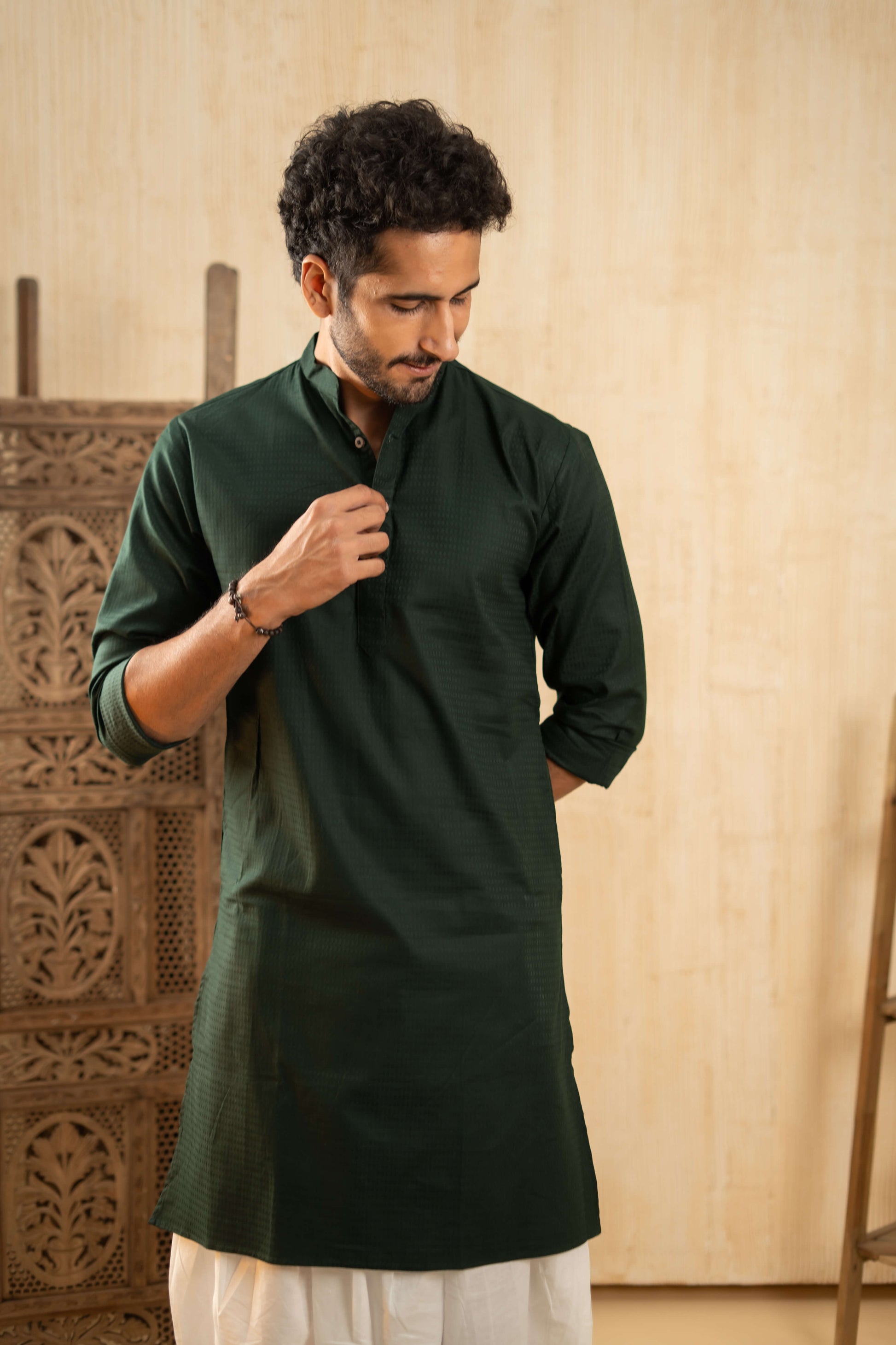 Indian man wearing solid green kurta with white dhoti. emphasizing traditional clothing with vibrant colors. 