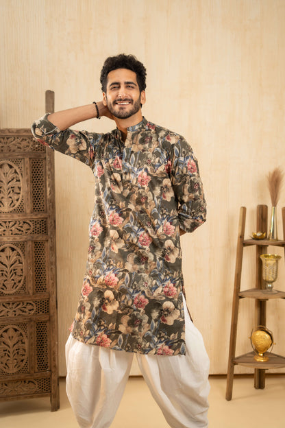 An Indian man wearing a purple kurta with a dhoti stands indoors