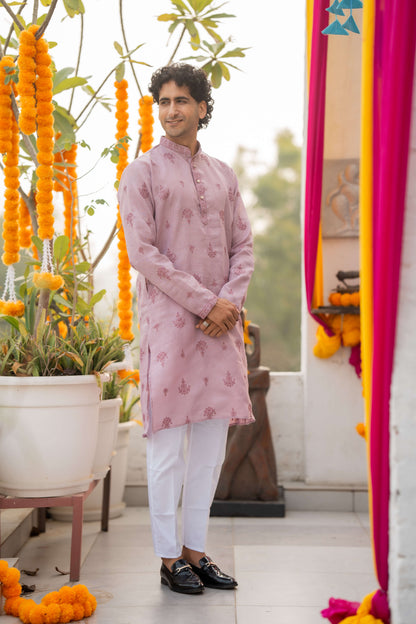 Indian man wearing a pink color kurta with white pant