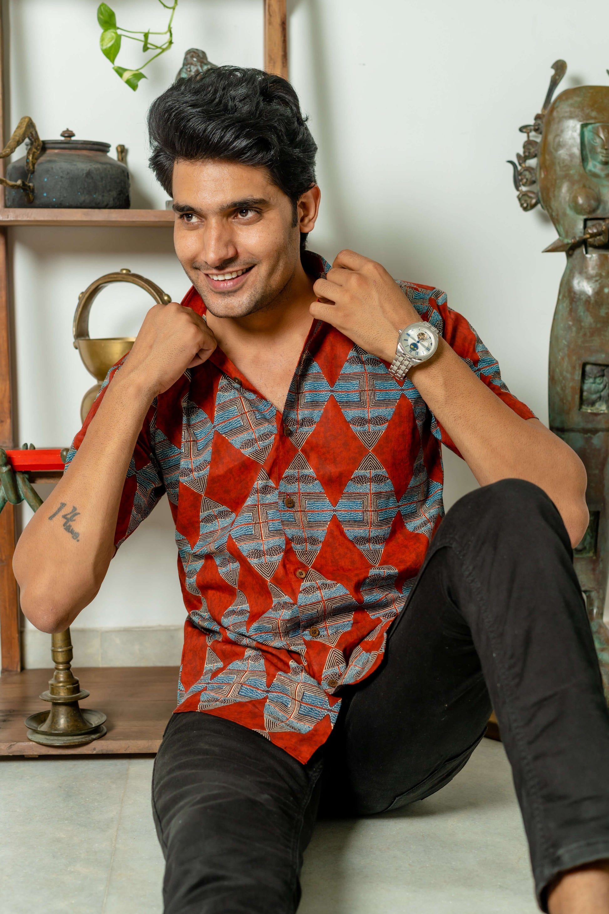 red printed shirt for men. worn by an indian man. 