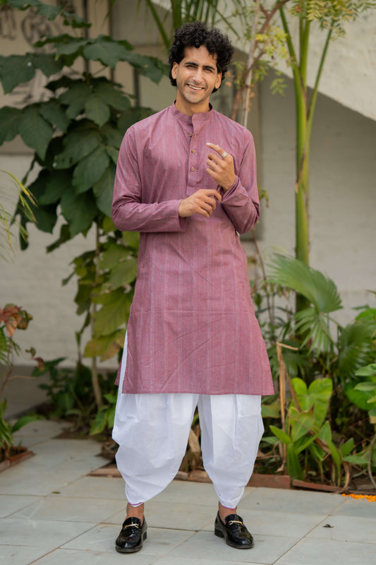 Indian man wearing purple long kurta featuring stripe print. 