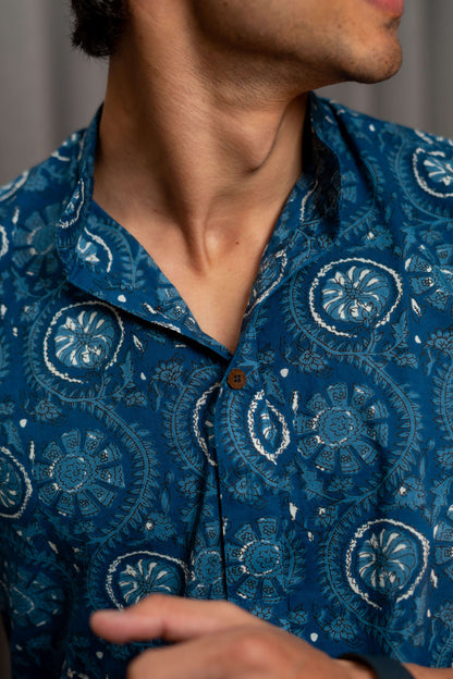 close view of blue short kurta with white floral print. 