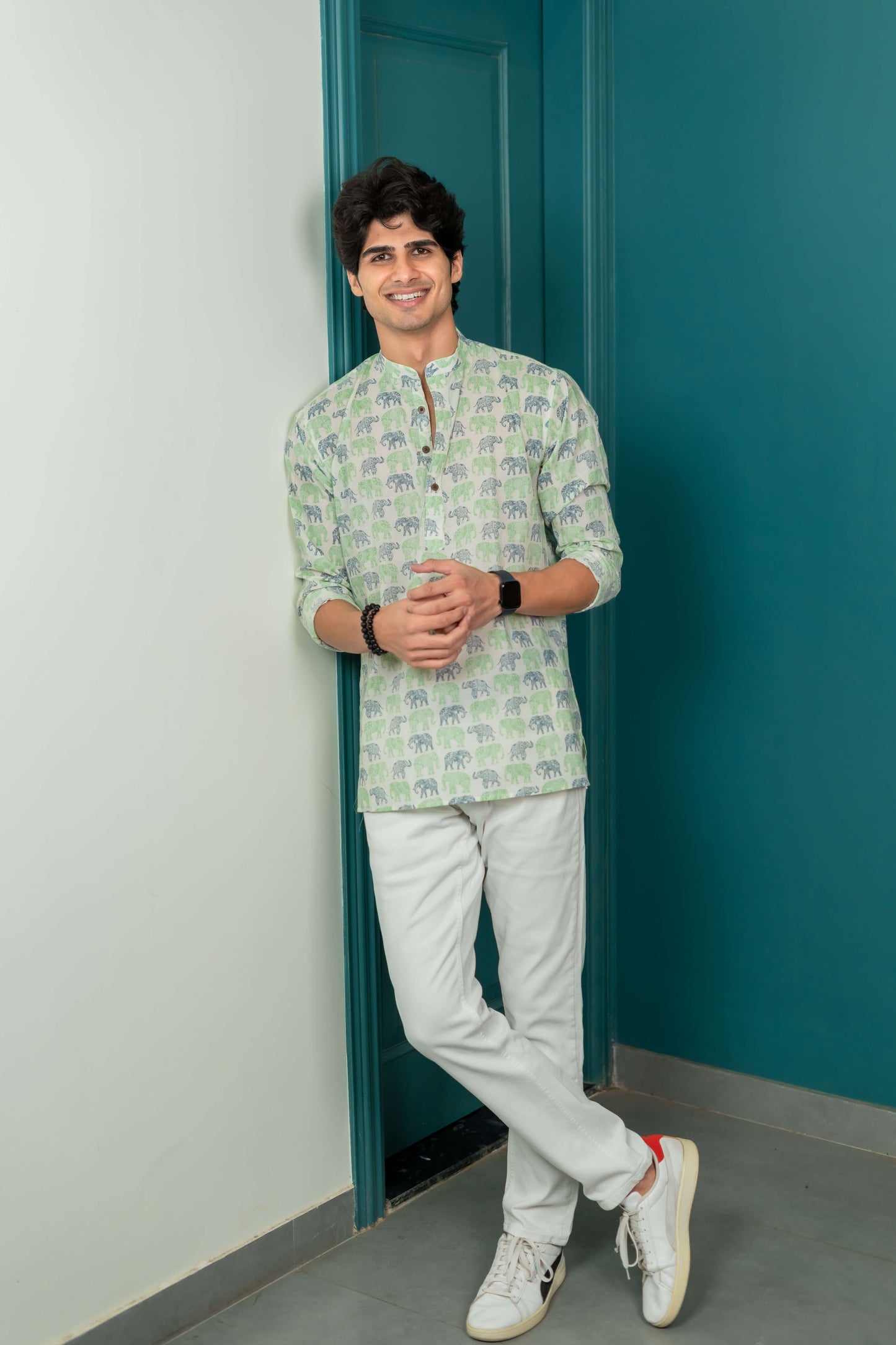 The White Short Kurta With Blue and Green Elephant Print.