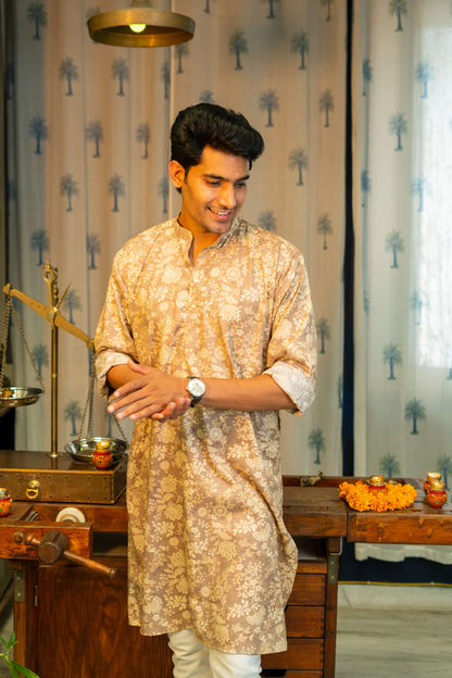 an Indian man wearing a brown color long kurta with an off-white floral print by shasak clothing