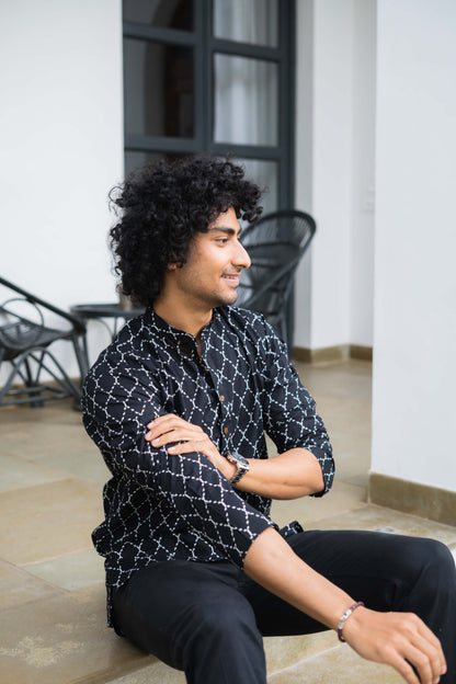 Indian man wearing black color short kurta